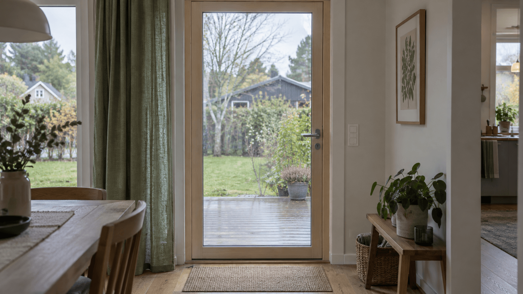 Stängd glasad altandörr med handtag och utsikt mot en trädgård.